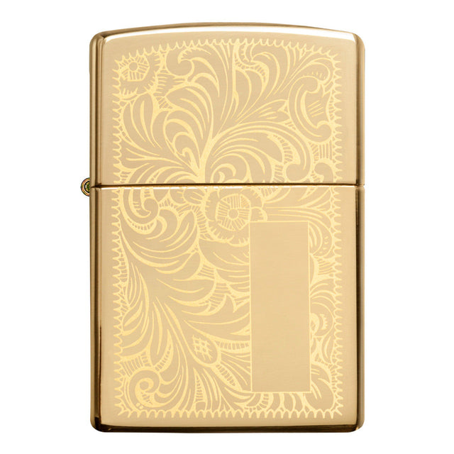 Gold-colored Zippo lighter with an ornate floral engraving pattern.