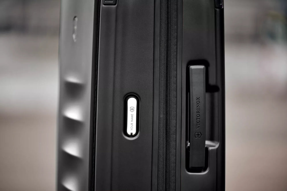 Close-up view of a black suitcase or luggage handle.