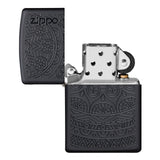 Zippo lighter with intricate engraved geometric patterns on a matte black finish.