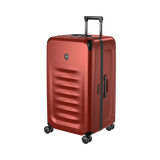 Red hardshell rolling suitcase with horizontal ridges and a retractable handle.