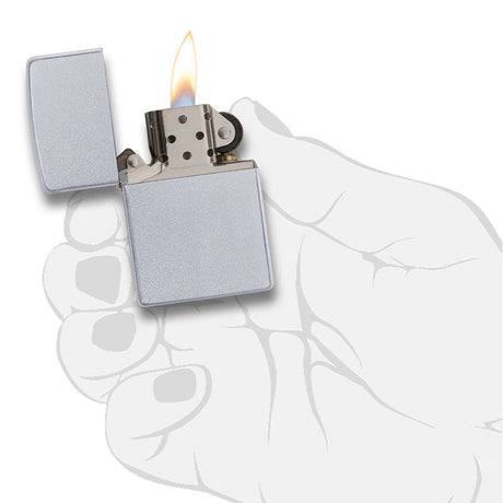 Lit silver metal lighter held in a hand.