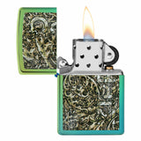 Zippo-style lighter with an intricate green and black floral design on its case, shown open with a flame lit.