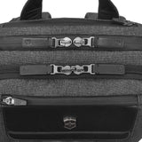 Backpack with multiple zippered compartments and buckle closures.