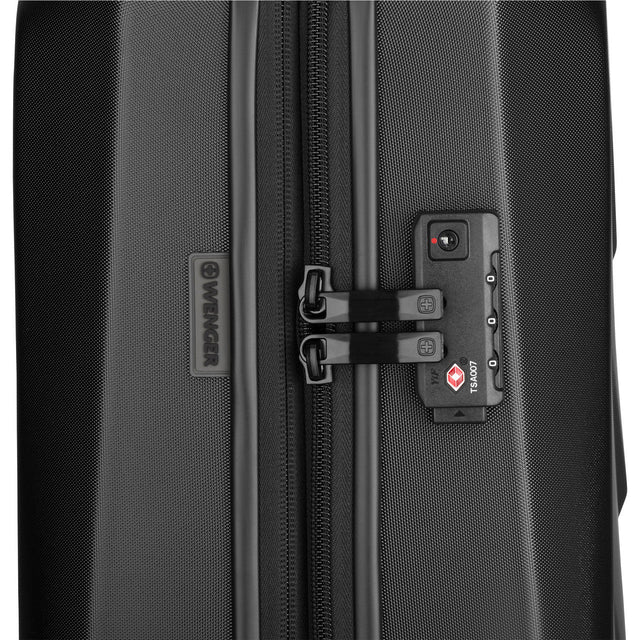 TSA-approved lock on a black hardshell suitcase zipper.
