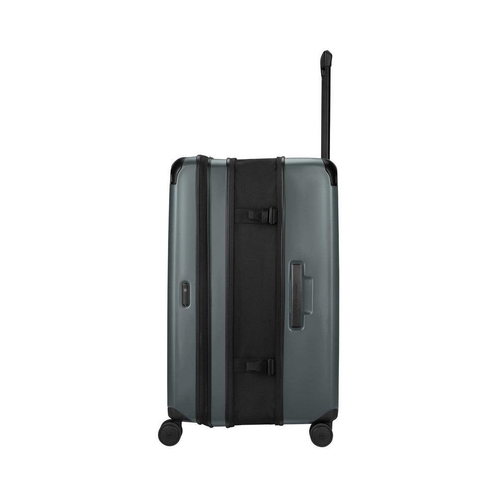 Gray hardshell rolling suitcase with an extendable handle.