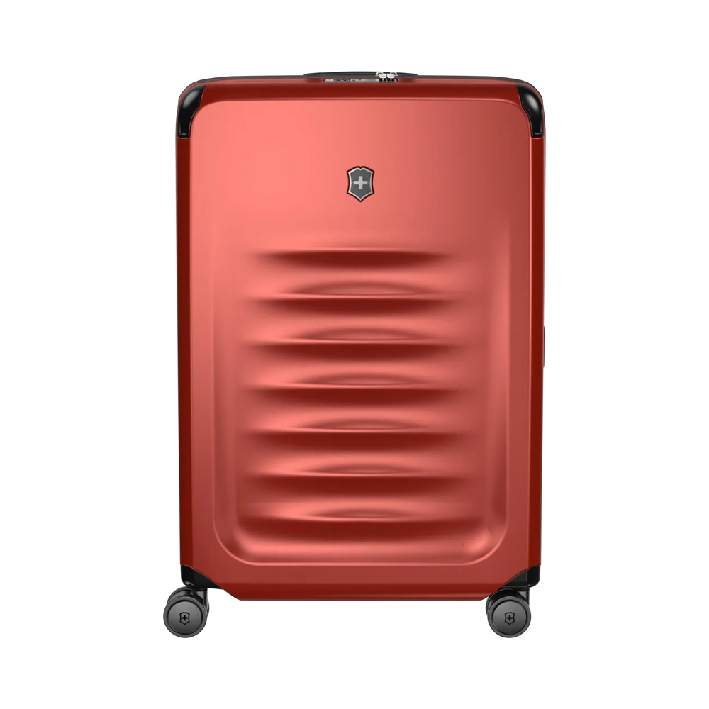 Red hardshell rolling suitcase with horizontal ridges and a logo emblem.