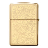 Gold-colored Zippo lighter with an ornate floral engraved pattern.
