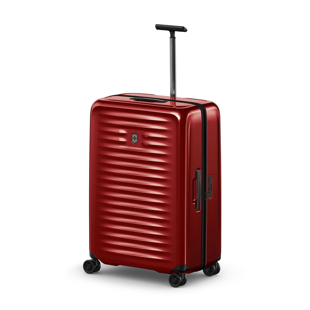 Red hardshell rolling suitcase with horizontal ridges and a retractable handle.