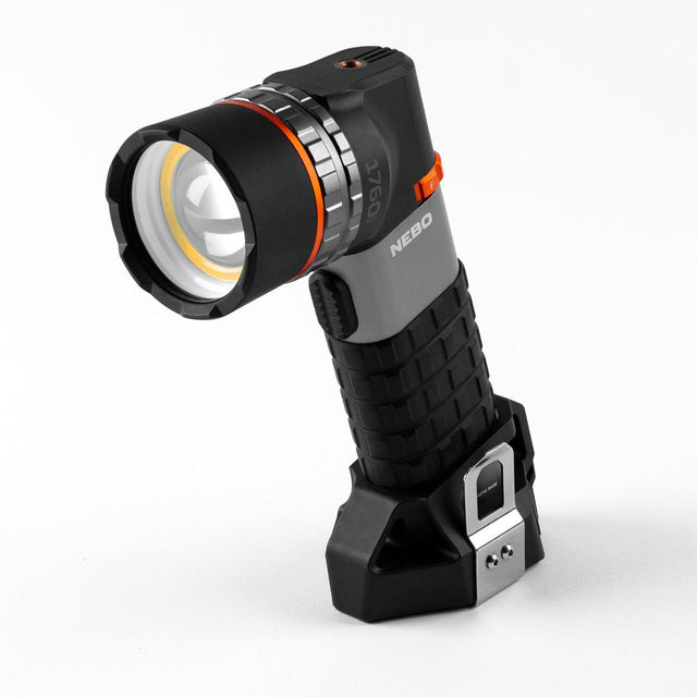 Handheld flashlight with an adjustable head and textured grip.