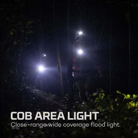 Bright flood light illuminating a dark outdoor area at night.