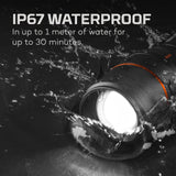 Waterproof light or flashlight submerged in water with splashes around it.