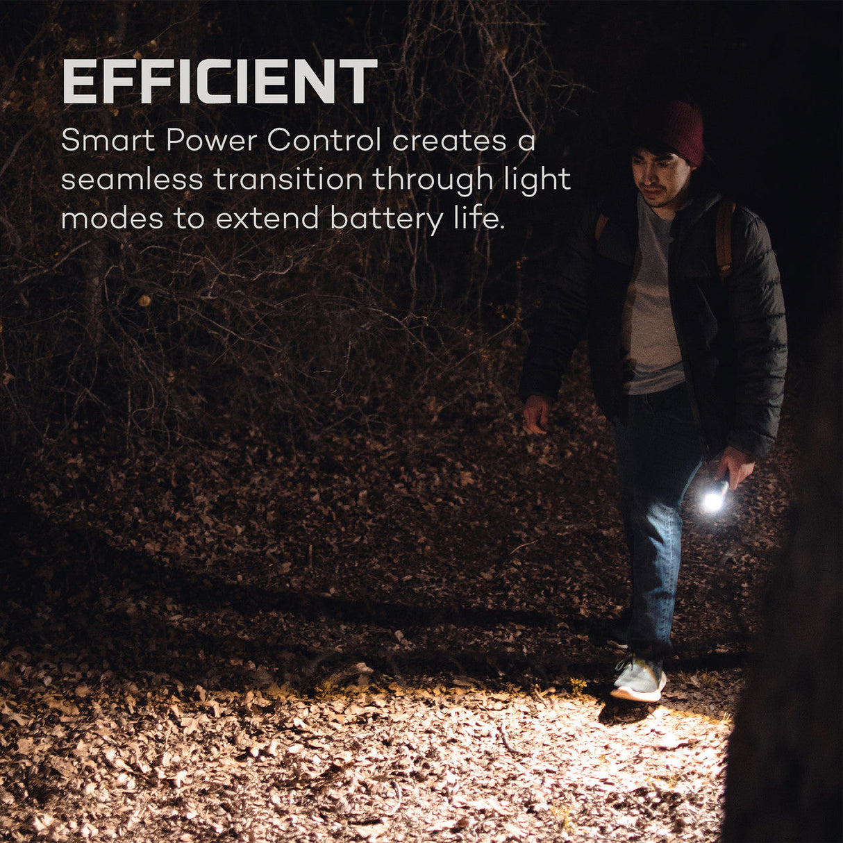 Person walking at night using a handheld flashlight or torch.