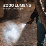 Handheld flashlight emitting an intense beam of white light.