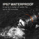 Waterproof flashlight submerged in water with bubbles surrounding it.