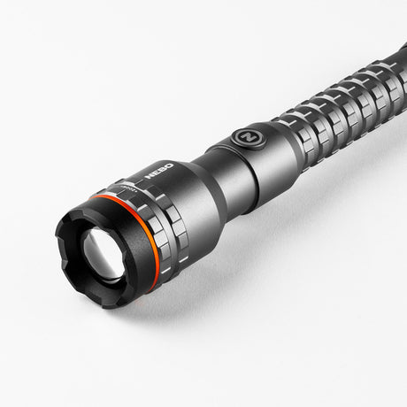 Metallic flashlight with a textured grip and adjustable focus ring.