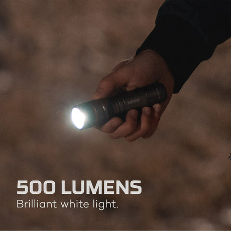 Handheld flashlight emitting a bright beam of light.