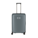 Gray hardshell rolling suitcase with horizontal ridges and an extendable handle.