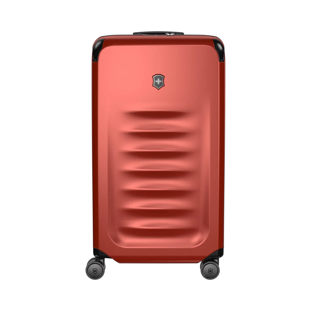 Red hardshell rolling suitcase with horizontal ridges and a logo emblem.