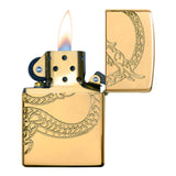 Gold-colored Zippo lighter with an engraved dragon design, shown lit.