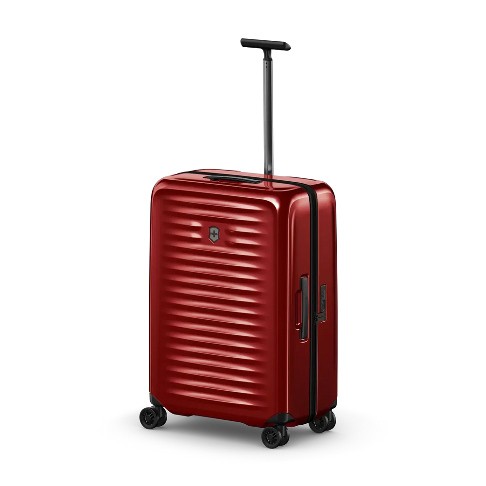 Red hardshell rolling suitcase with horizontal ridges and an extendable handle.