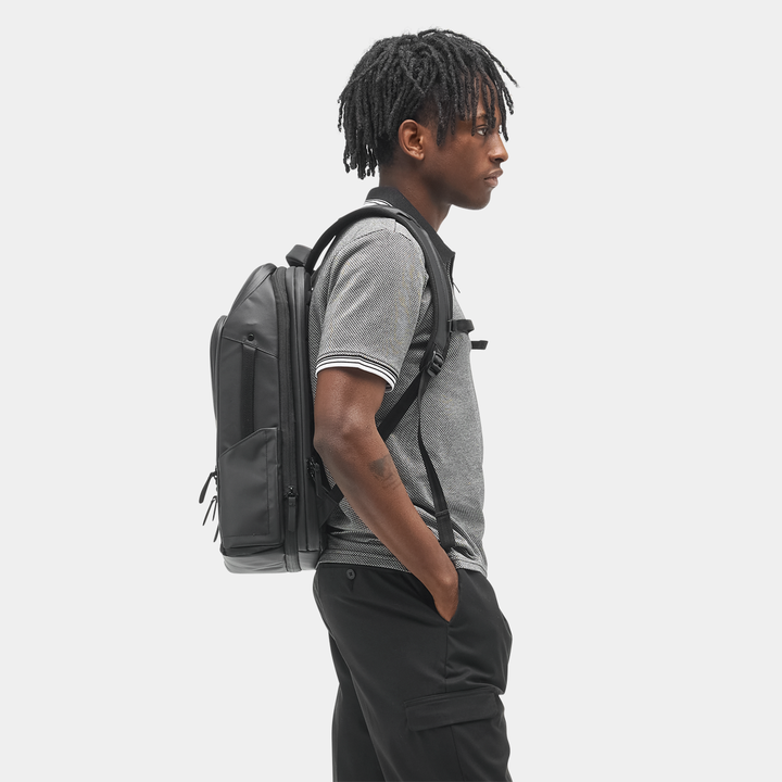 Travel Pack 14L side view showing the magnetic water-bottle pocket
