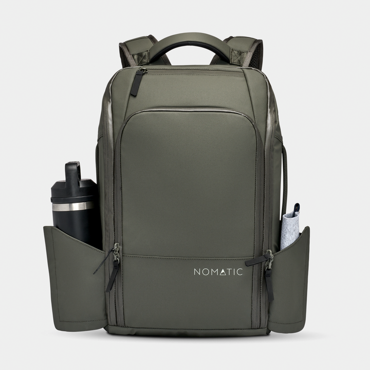 Travel Pack 14L in olive with a bottle in the magnetic pocket