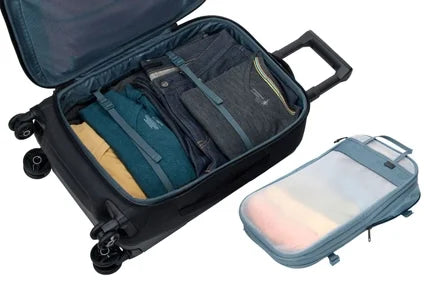 Thule Aion carry-on spinner open, with the compression cube beside it