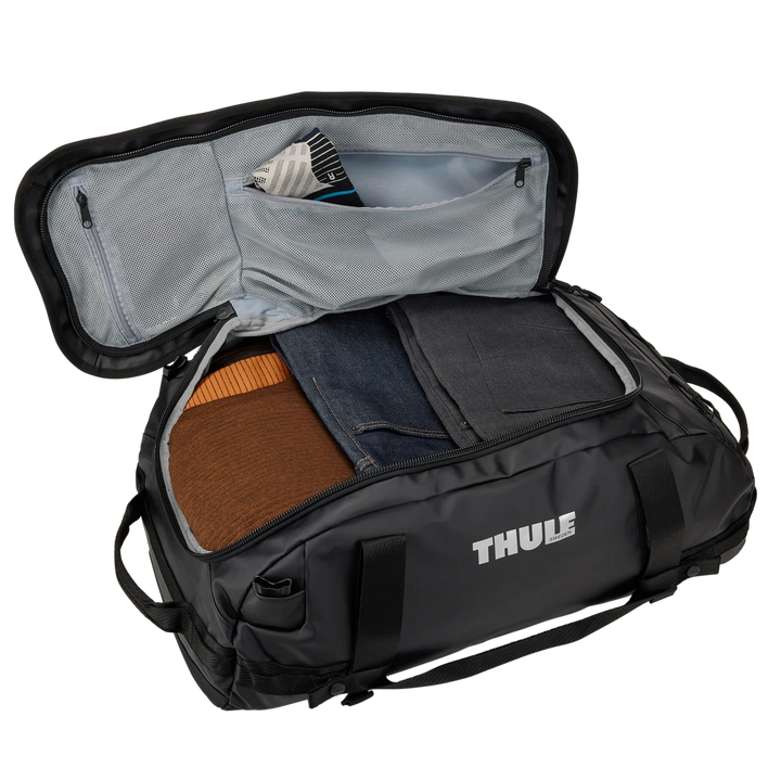 Thule Chasm duffel with its wide lid open, packed with clothes