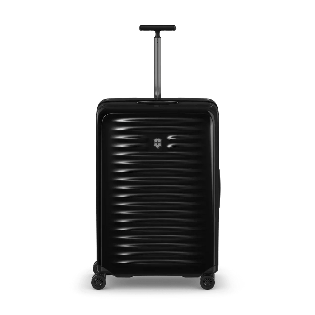 Black hard-shell rolling suitcase with horizontal ridges and an extendable handle.