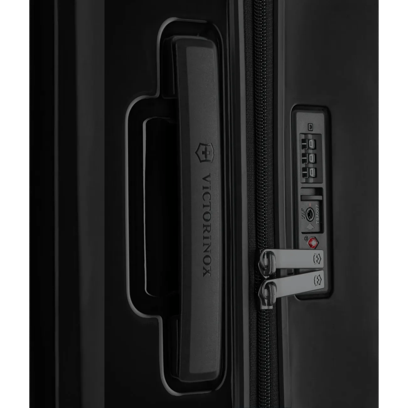 Luggage handle and combination lock on a black suitcase.