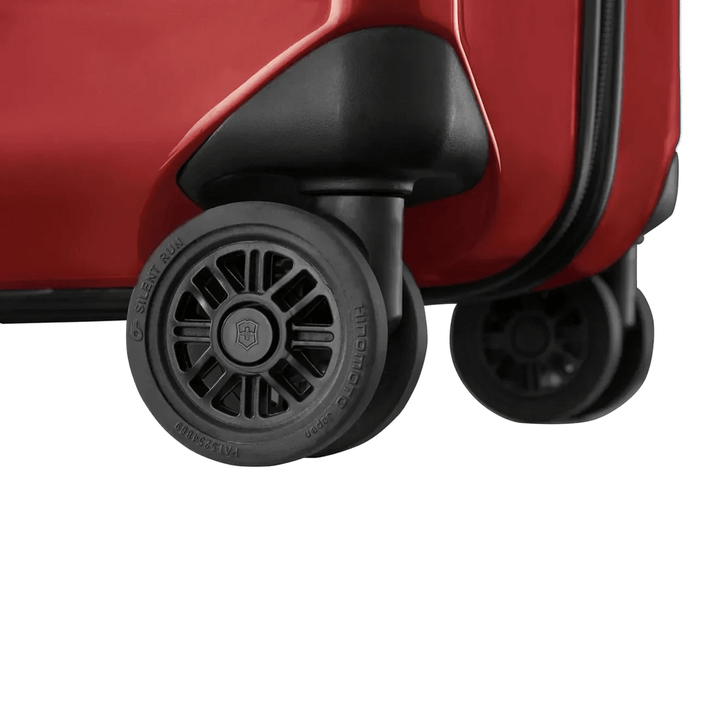 Wheels of a red suitcase or luggage.
