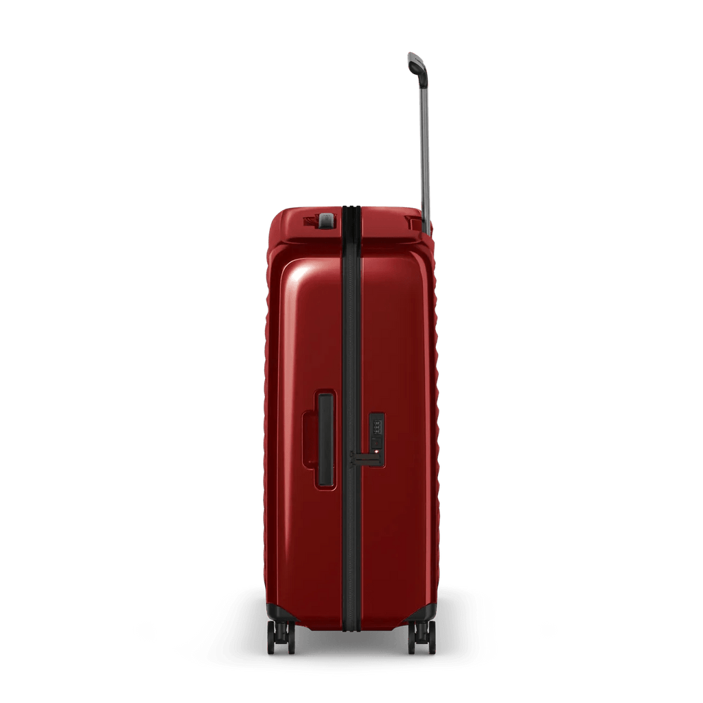 Red hardshell rolling suitcase with a telescoping handle and wheels.