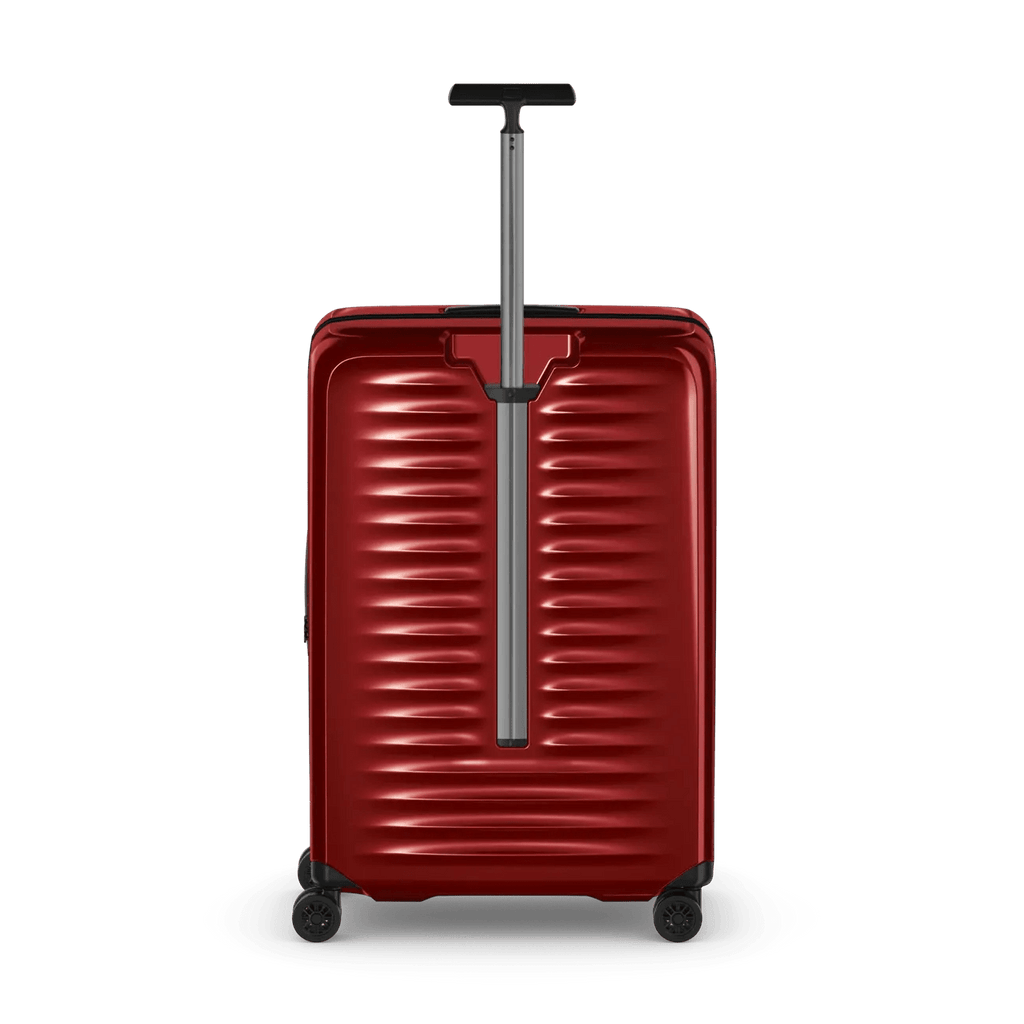 Red hardshell rolling suitcase with horizontal ridges and an extendable handle.