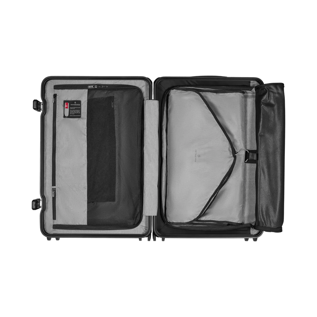 Open suitcase with compartments and straps for organizing contents.