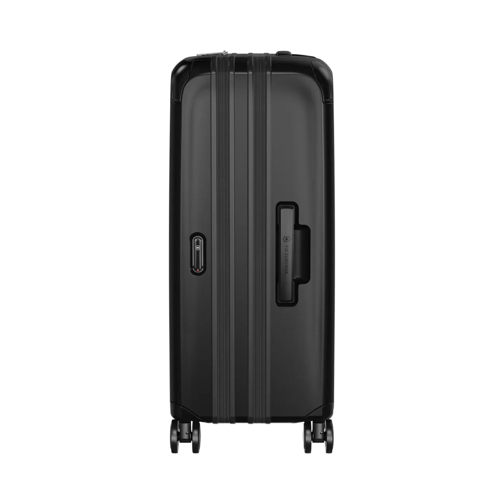 Black hardshell rolling suitcase with vertical ridges and a side handle.