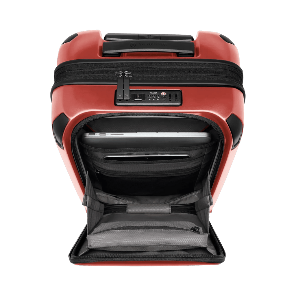 Red hardshell suitcase with an open front compartment and a combination lock.