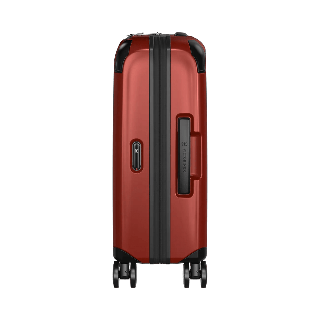 Red hardshell rolling suitcase with black trim and wheels.